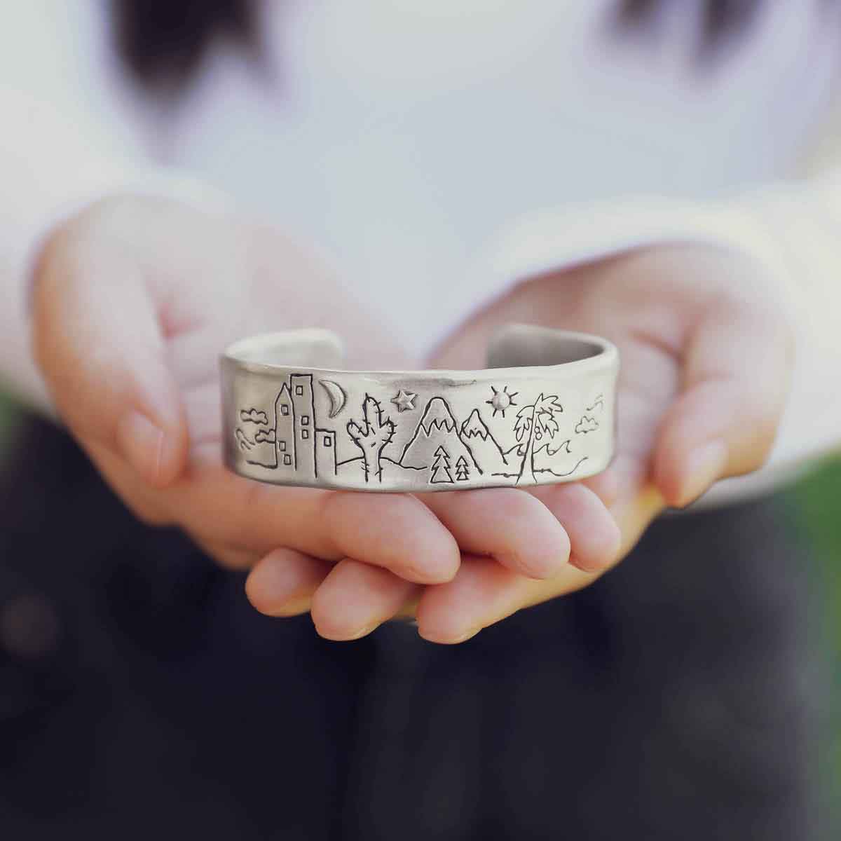 girl holding a Let's Explore Together Cuff