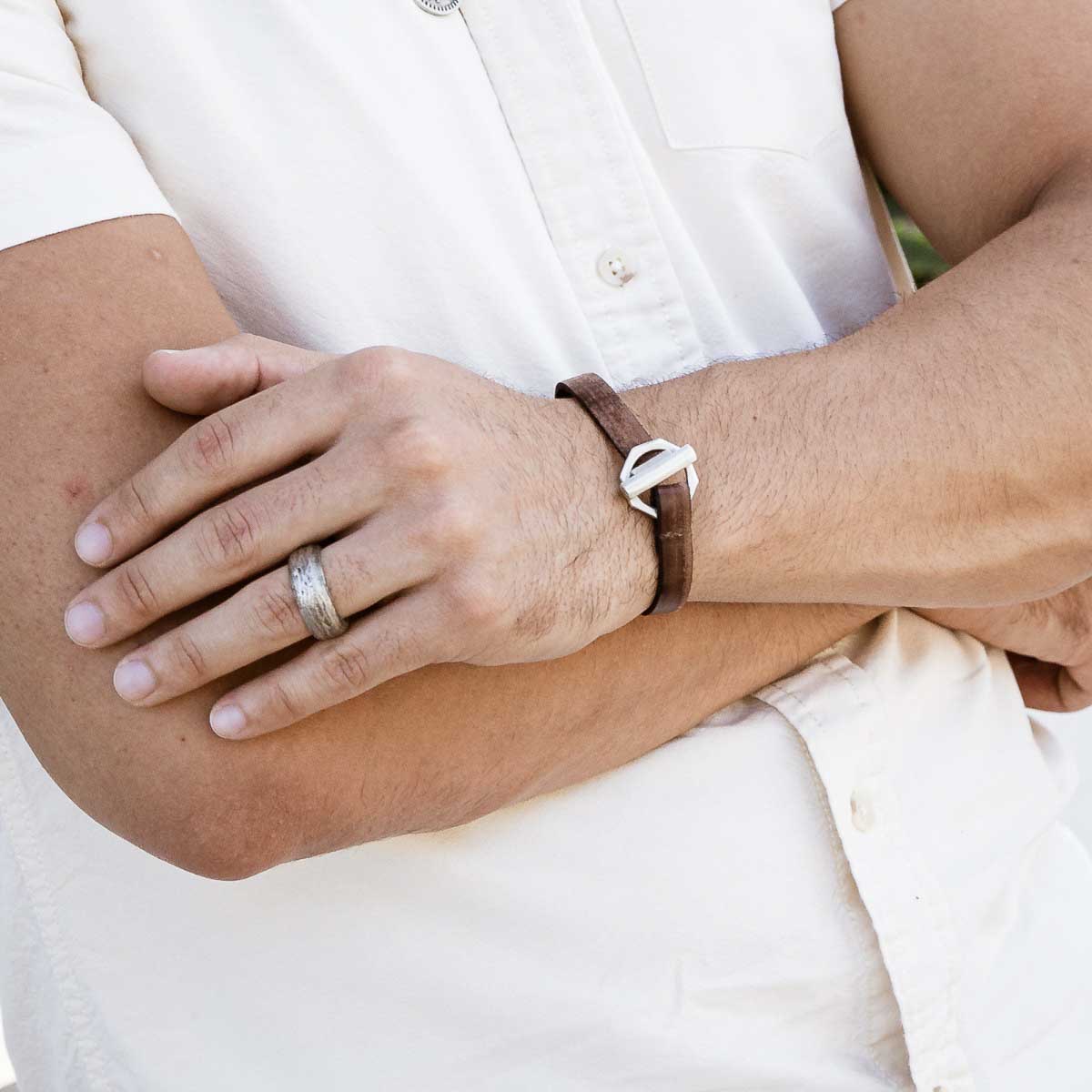 Man wearing Life Forever bracelet handcrafted in water buffalo brown leather and a sterling silver toggle closure