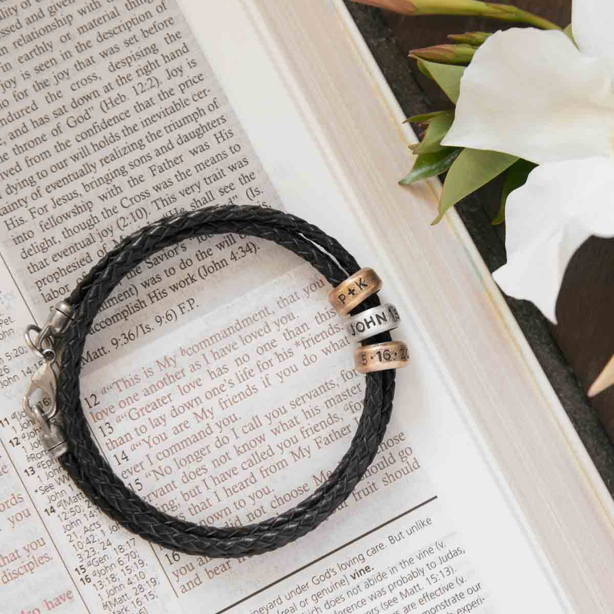 Limitless Leather bracelet handcrafted with black bolo leather cord and choice of personalized sterling silver and bronze limitless rings