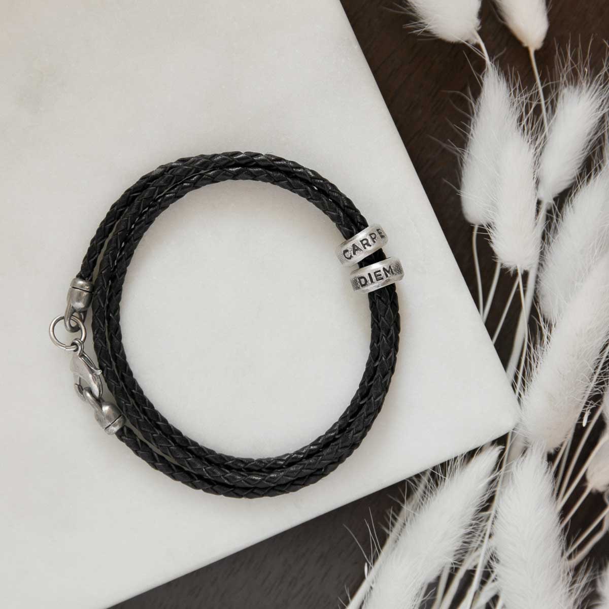 Limitless Leather bracelet handcrafted with black bolo leather cord and choice of personalized sterling silver and bronze limitless rings