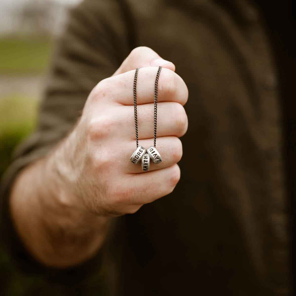 hand holding a Limitless Necklace