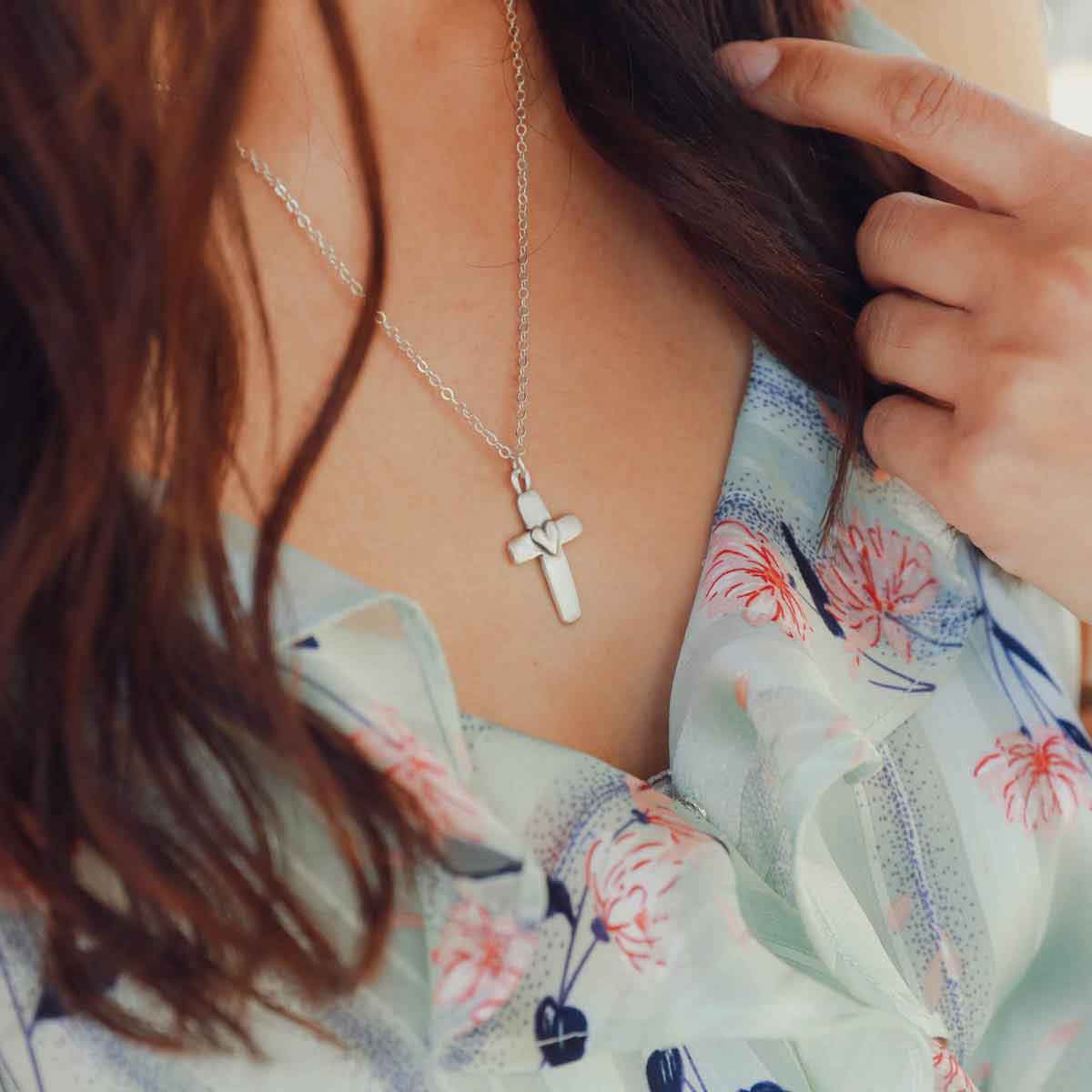 girl wearing a sterling silver cross of faith necklace