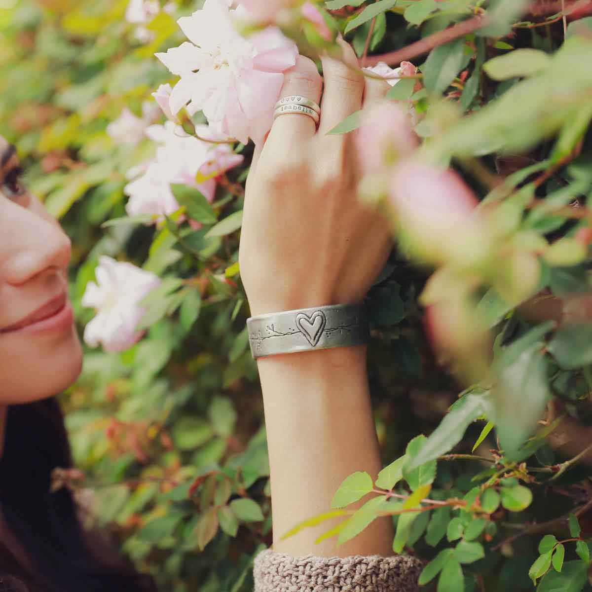 girl wearing pewter let love grow cuff