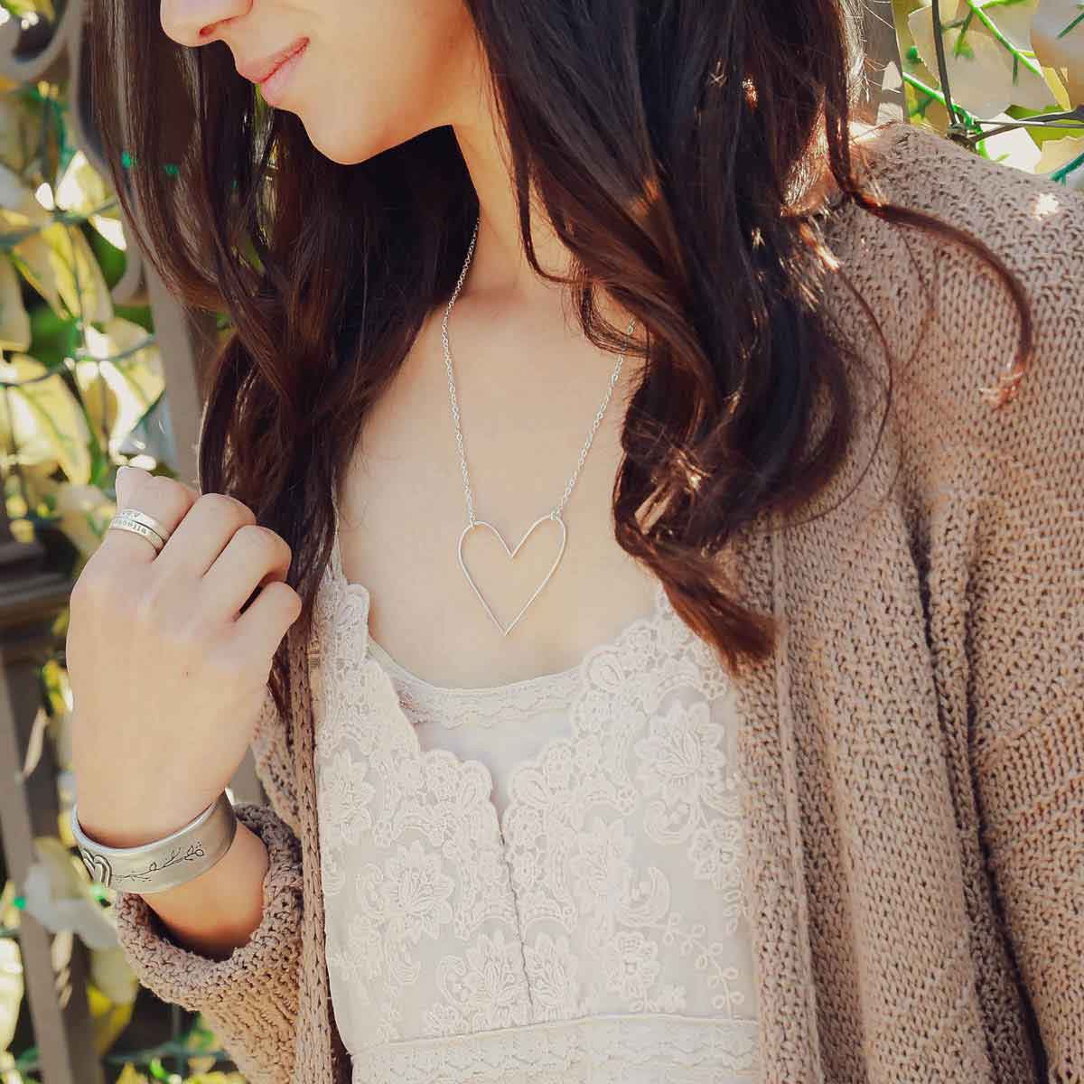 girl wearing a Peaceful Heart Necklace handcrafted in sterling silver