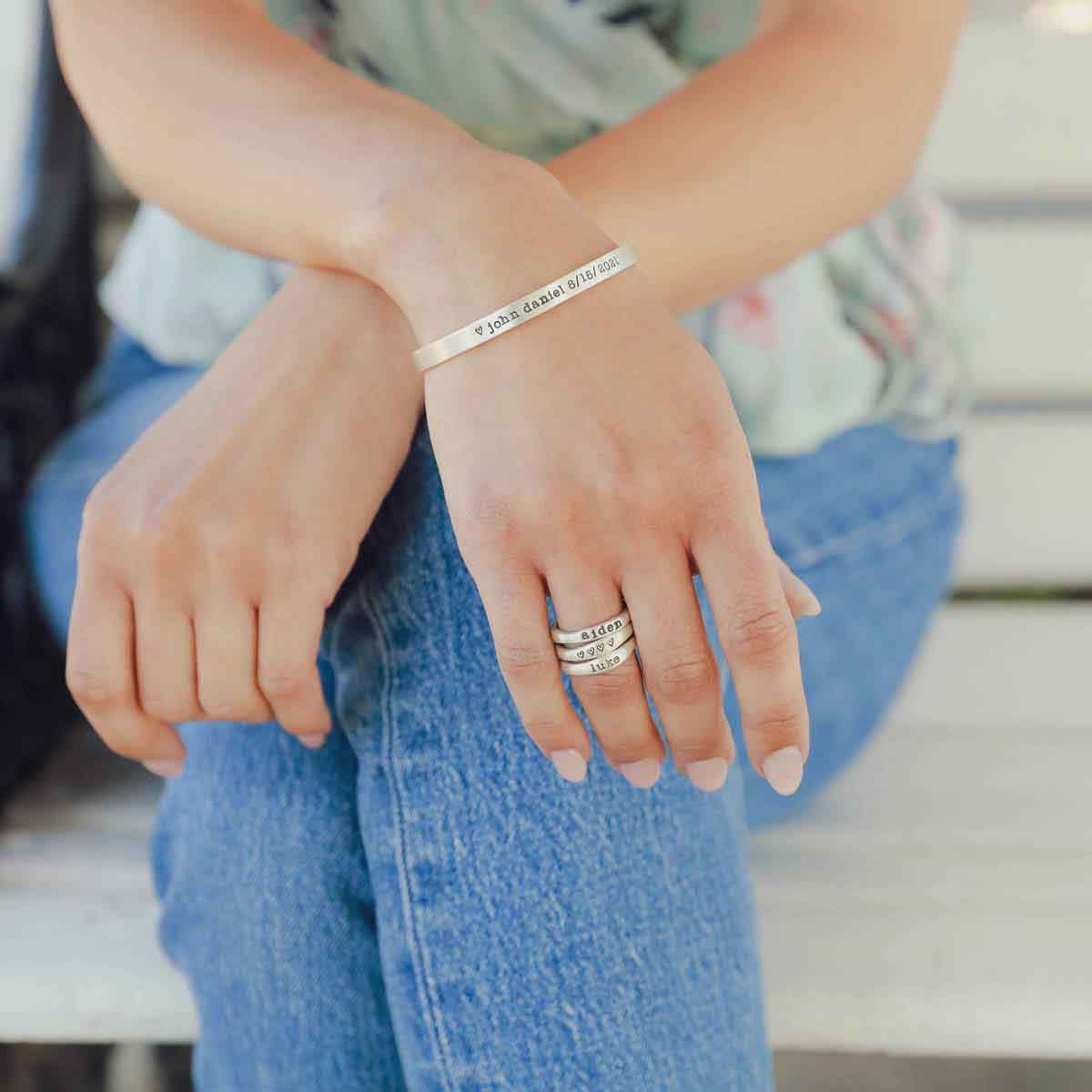 Girl wearing her personalized sterling silver jewelry including her thin sterling cuff