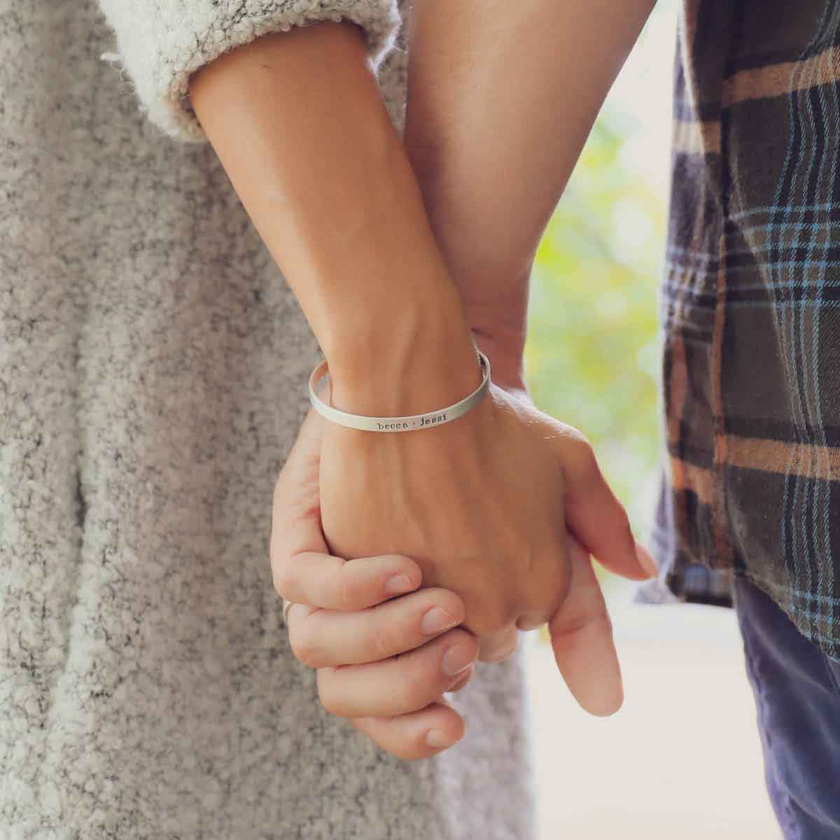 girl wearing thin sterling silver cuff hugging boyfriend