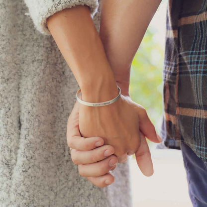 girl wearing thin sterling silver cuff hugging boyfriend