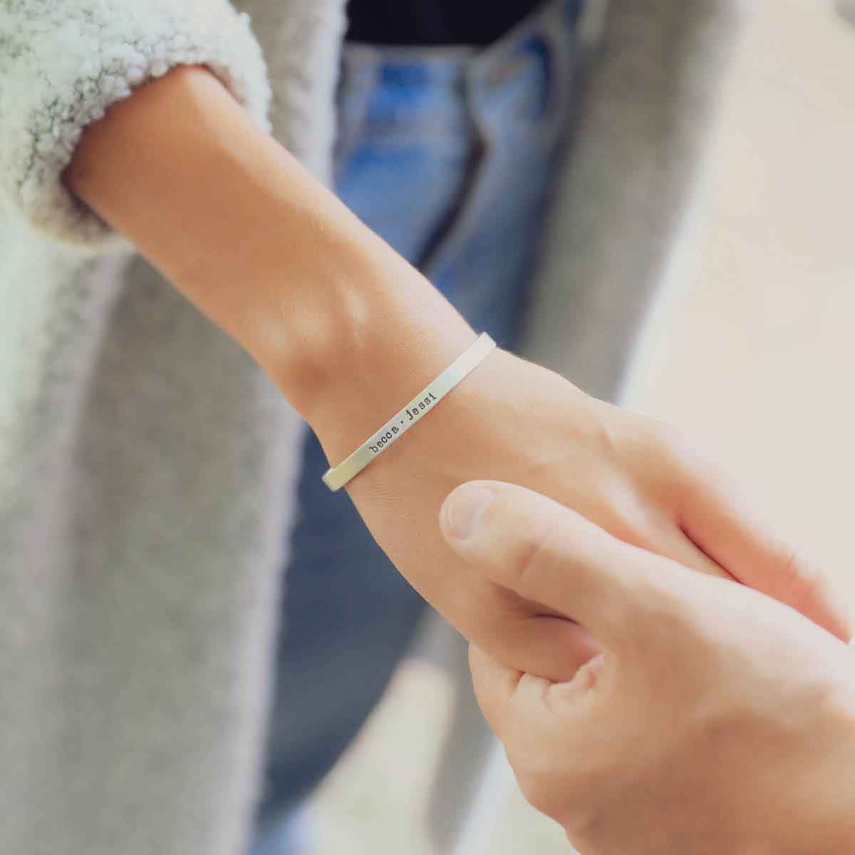 girl wearing personalized sterling silver thin cuff