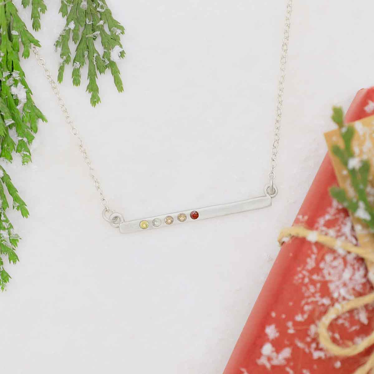 sterling silver cross bar birthstone necklace strung on a silver link chain customizable with up to 7 genuine 2mm birthstones