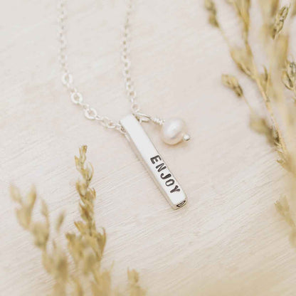 girl holding word of the year necklace in lisa leonard necklace box