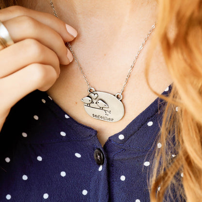 girl holding a pewter Better Together necklace