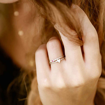 Girl wearing love and loss ring pair hand-molded and cast in sterling silver with genuine stones