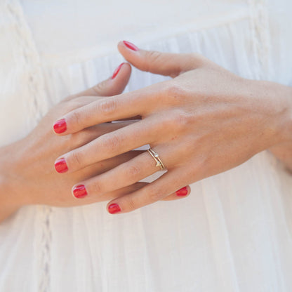 Girl wearing love and loss ring pair hand-molded and cast in 10k yellow gold with genuine stones or conflict free genuine diamonds 