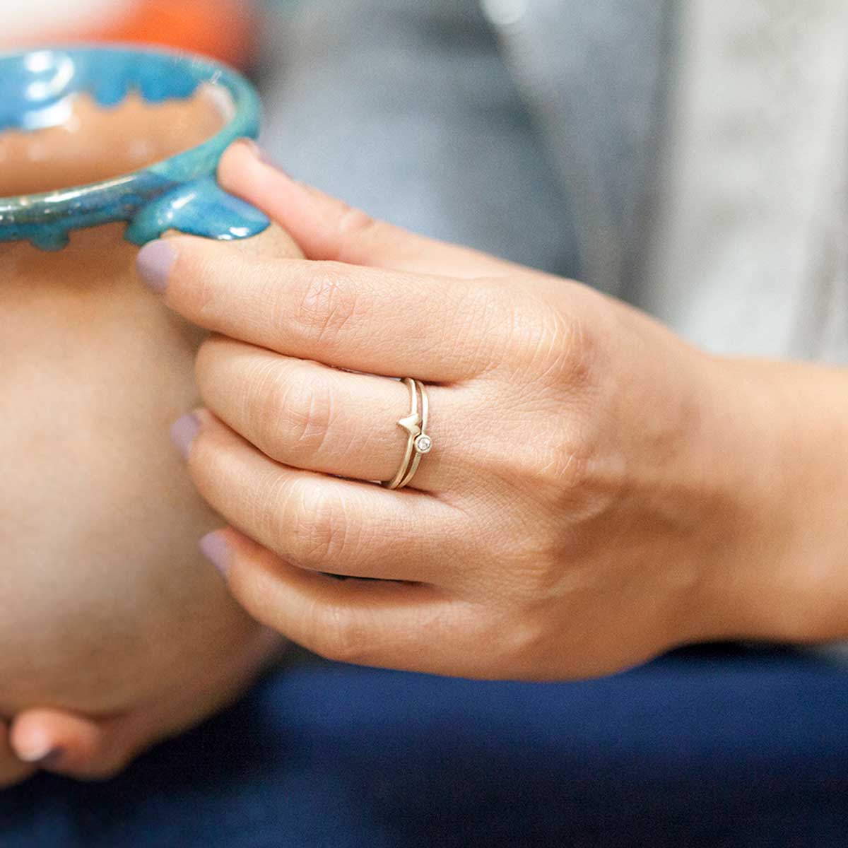 Girl wearing love and loss ring pair hand-molded and cast in 14k yellow gold with genuine stones or conflict free genuine diamonds 