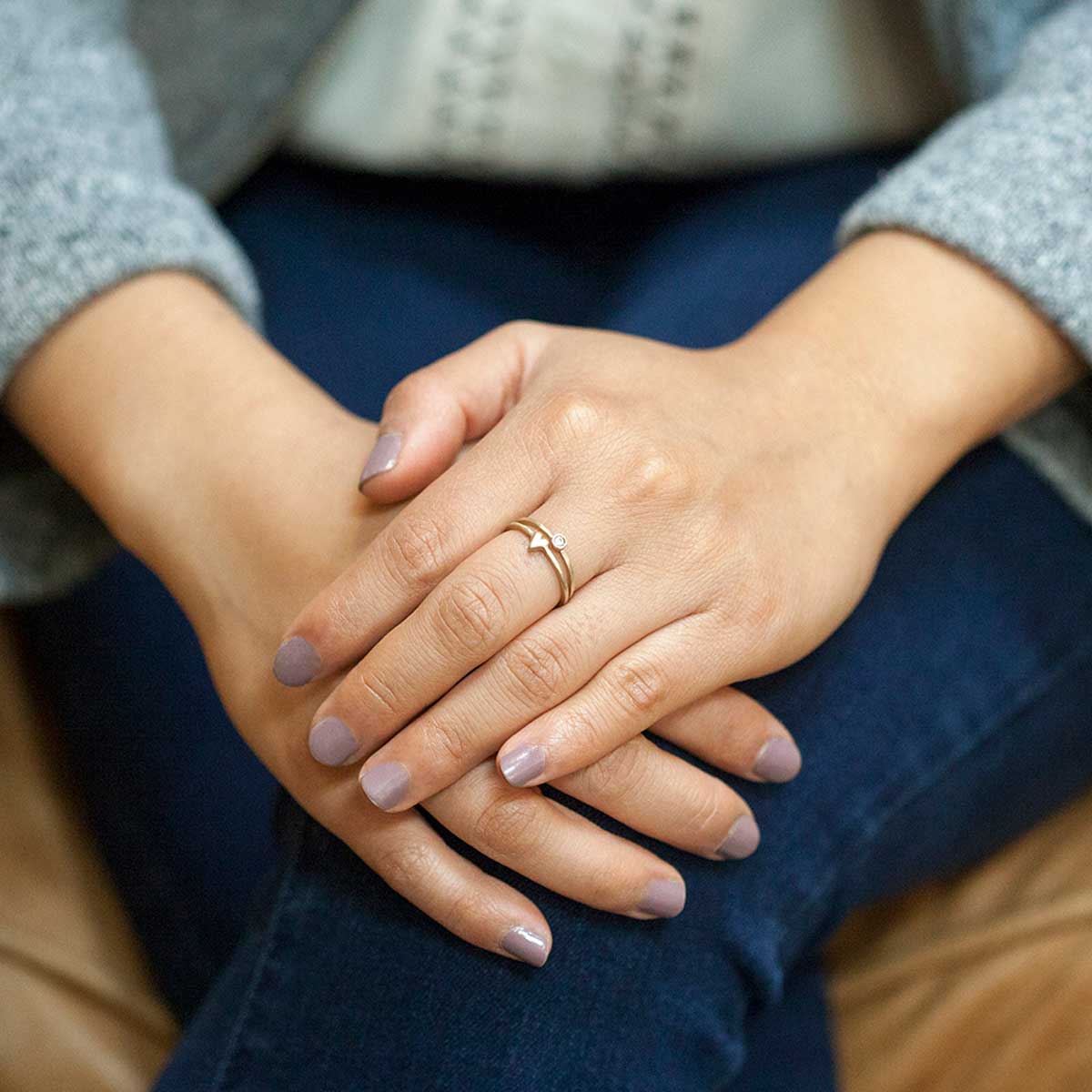 Girl wearing love and loss ring pair hand-molded and cast in 10k yellow gold with genuine stones or conflict free genuine diamonds 