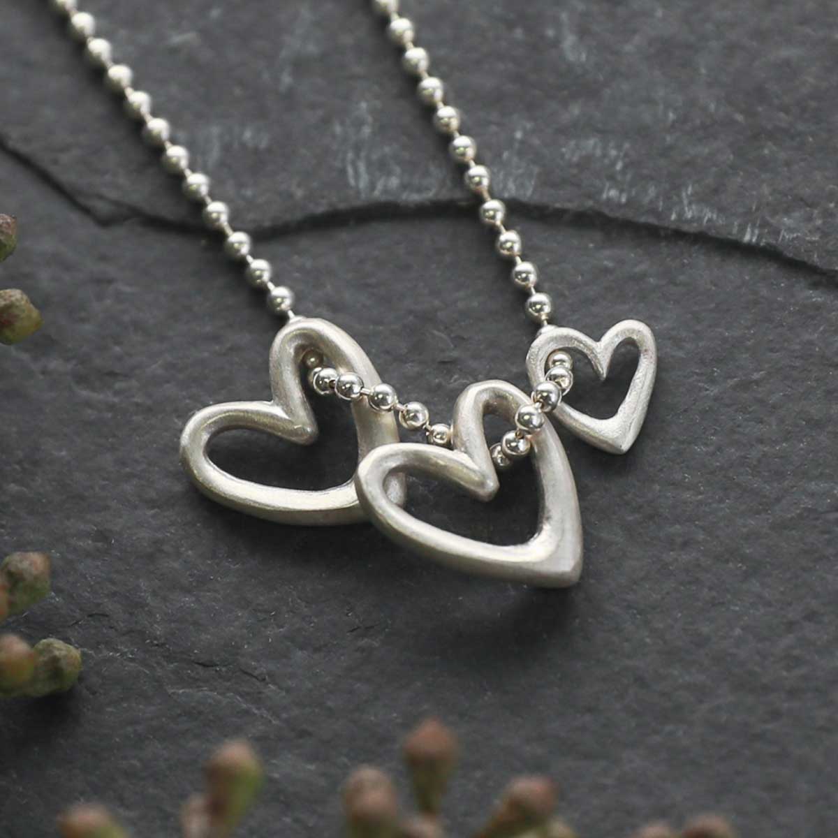 Love Grows necklace handcrafted in sterling silver with the heart charm strung on sterling silver chain