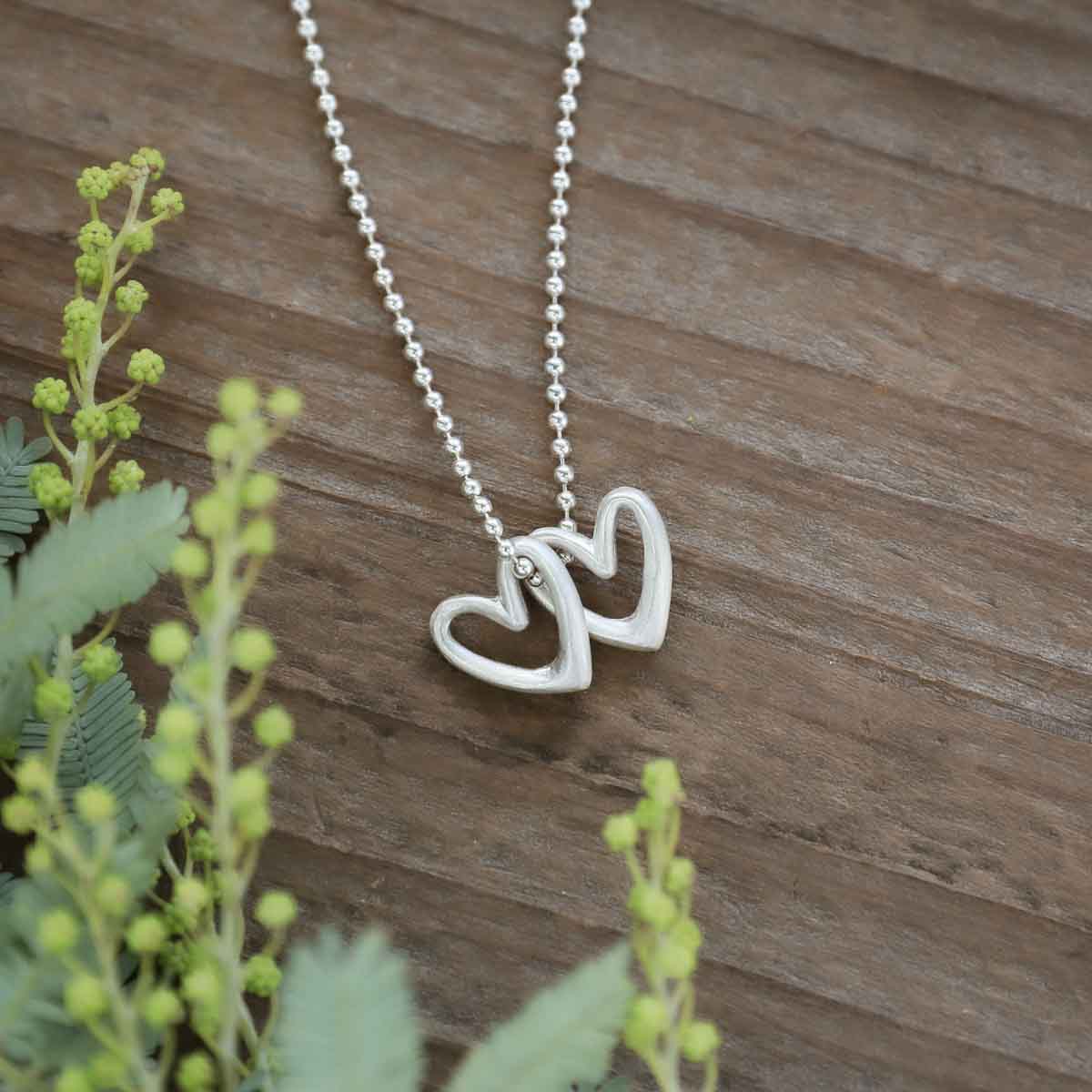 Love Grows necklace handcrafted in sterling silver with the heart charm strung on sterling silver chain