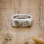 an antiqued sterling silver Make Your Mark Signet ring, personalized with monogram, on wood background