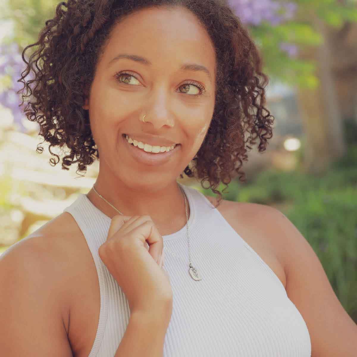 girl wearing a sterling silver March birth flower necklace