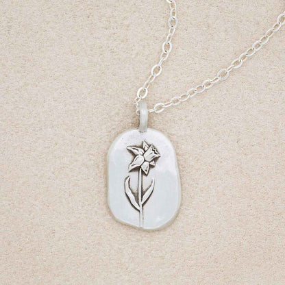 sterling silver March birth flower necklace, on beige background