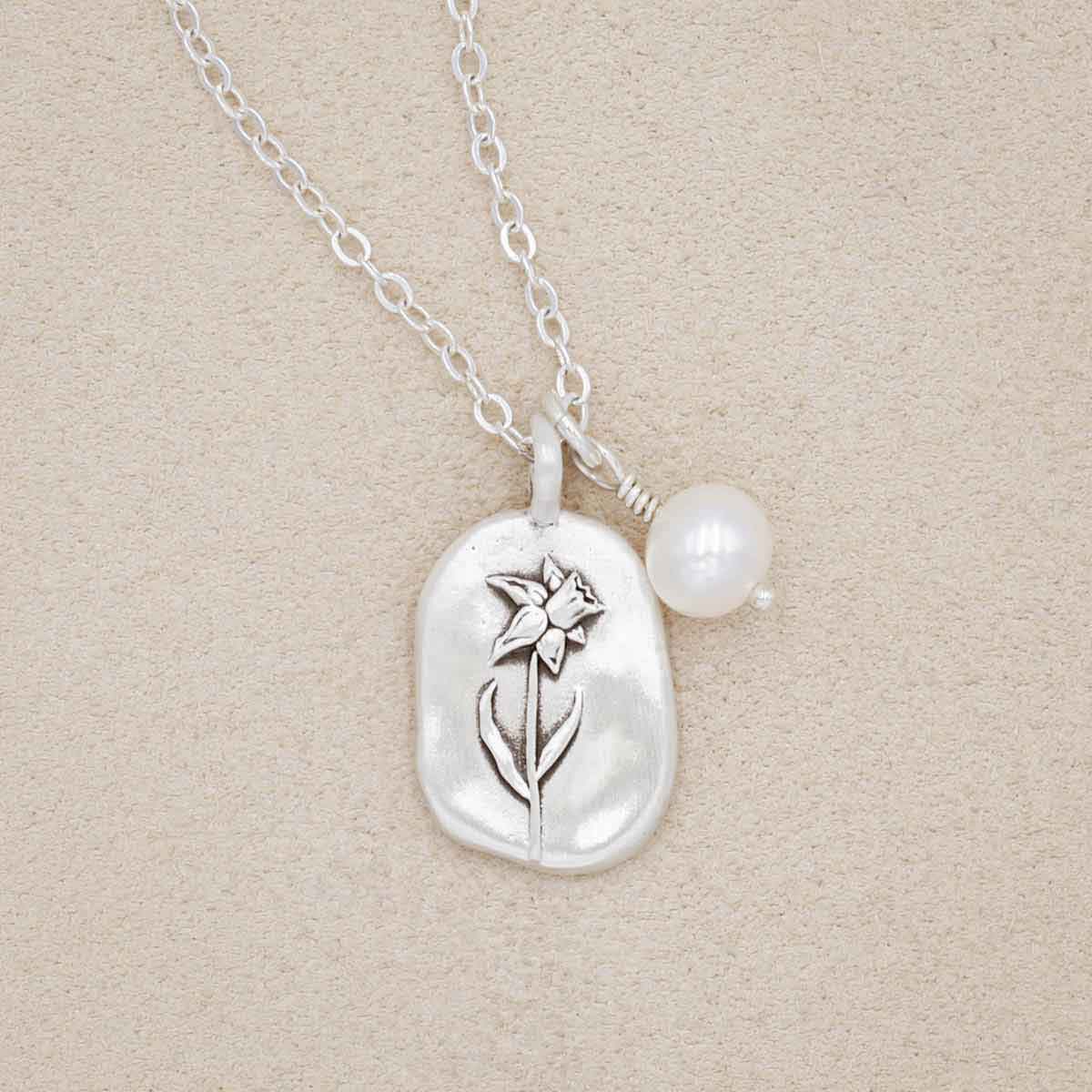 March birth flower necklace handcrafted in sterling silver with a special birth month charm strung with a vintage freshwater pearl