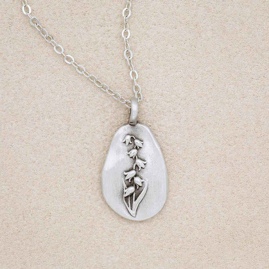 pewter May Birth Flower necklace with 18" link chain, on beige background