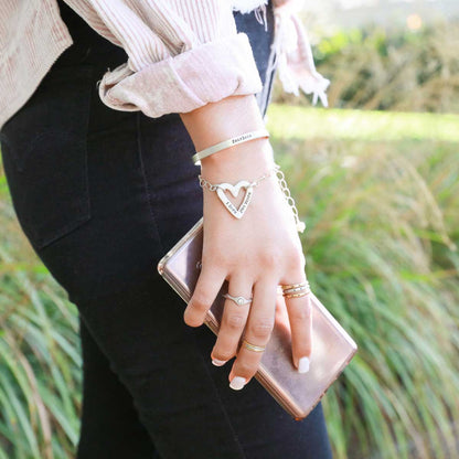 Girl wearing sterling silver jewelry along with her handcrafted molded heart bracelet with a freshwater pearl