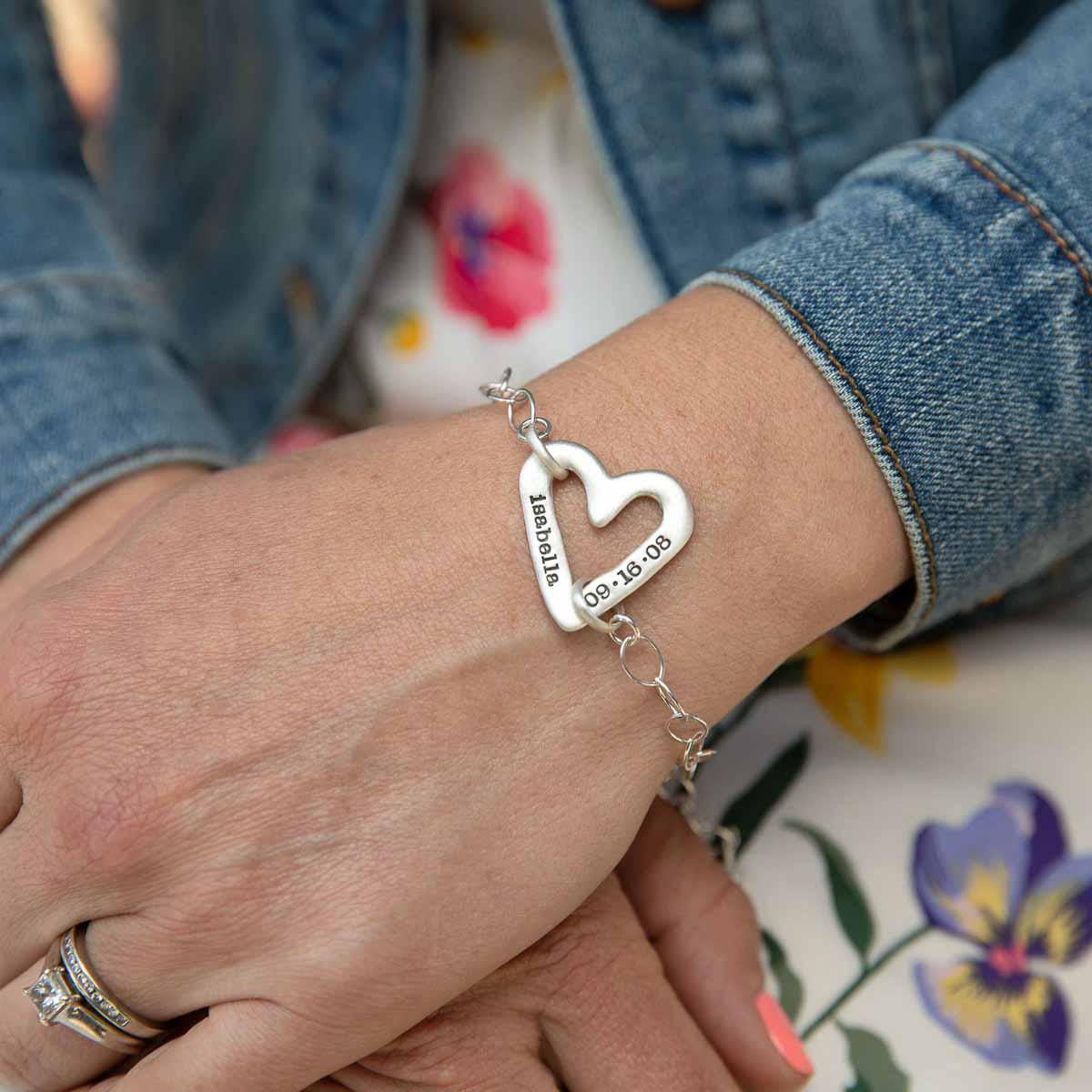 Girl wearing her Personalized sterling silver molded heart bracelet with a freshwater pearl