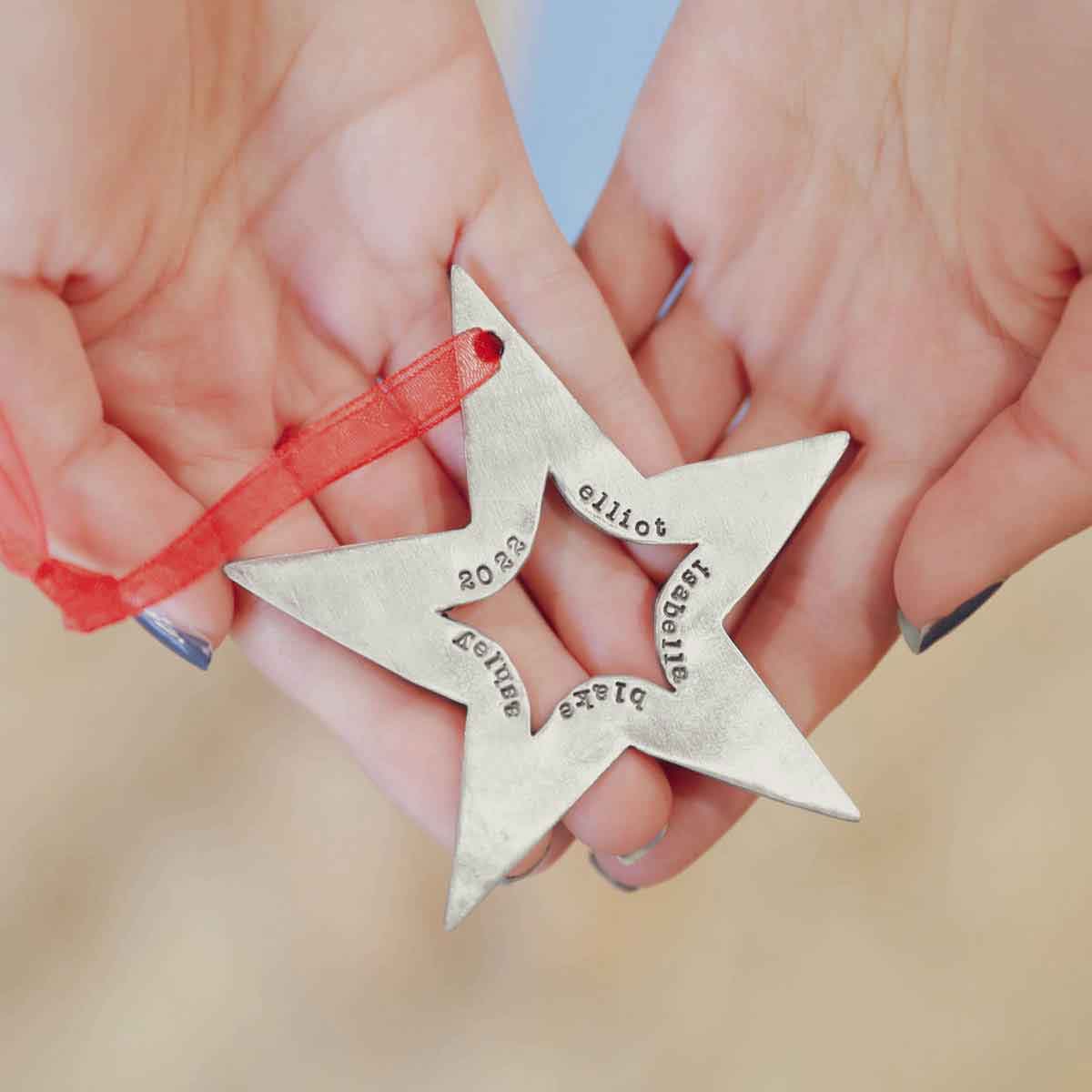 hand holding a Molded star ornament hand-molded and cast in fine pewter