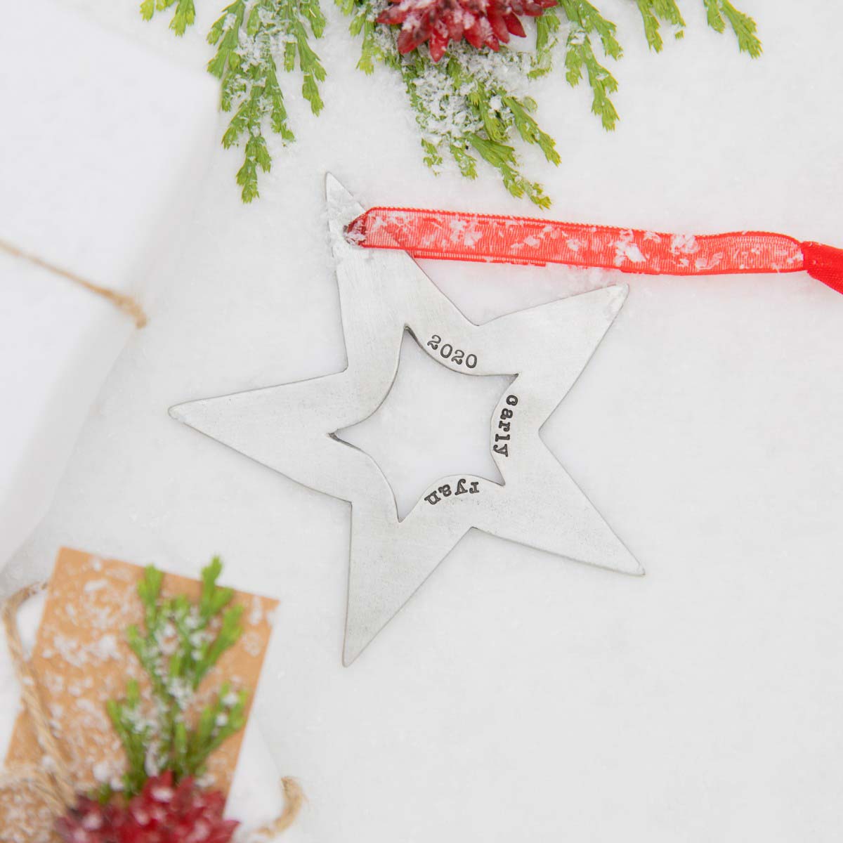 Molded star ornament hand-molded and cast in fine pewter hung from a sheer red ribbon and customizable with a up to five words