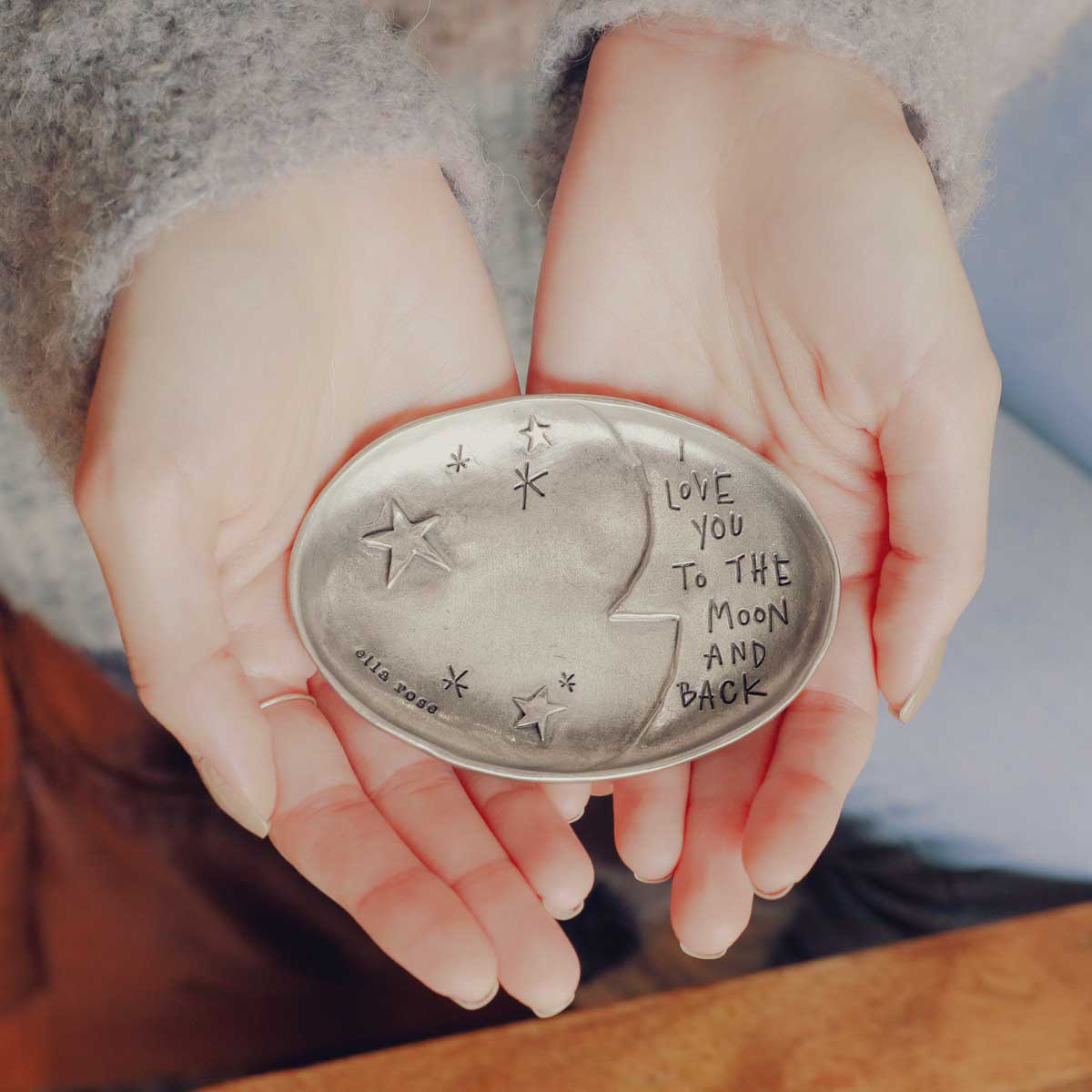 girl holding a Moon and back keepsake dish