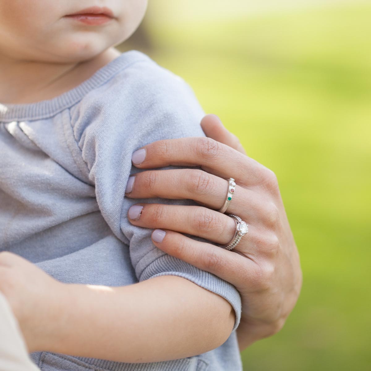 woman wearing her Handcrafted sterling silver mother's rings customizable with up to 6 genuine birthstones