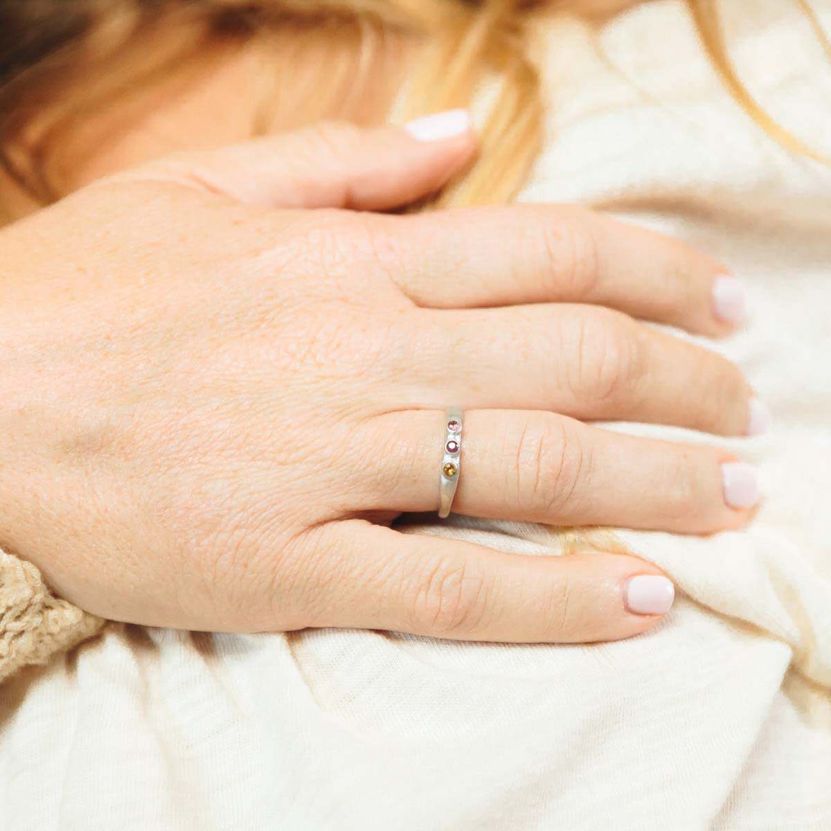 woman wearing her Handcrafted sterling silver mother's rings customizable with up to 6 genuine birthstones