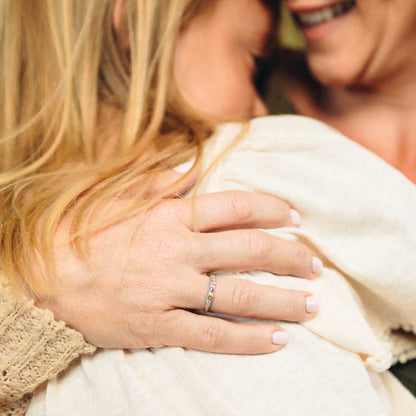 woman wearing her Handcrafted sterling silver mother's rings customizable with up to 6 genuine birthstones with her daughter