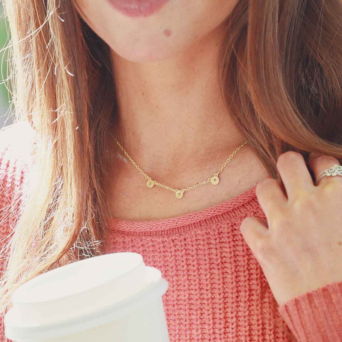 girl wearing 10k yellow gold my darling ones initial necklace personalized with 3 initials