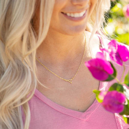 girl wearing 10k yellow gold my monogram letter necklace