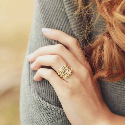 10k yellow gold personalized Nameplate Stacking Ring on a beige background