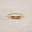 10k yellow gold personalized Nameplate Stacking Ring on a beige background