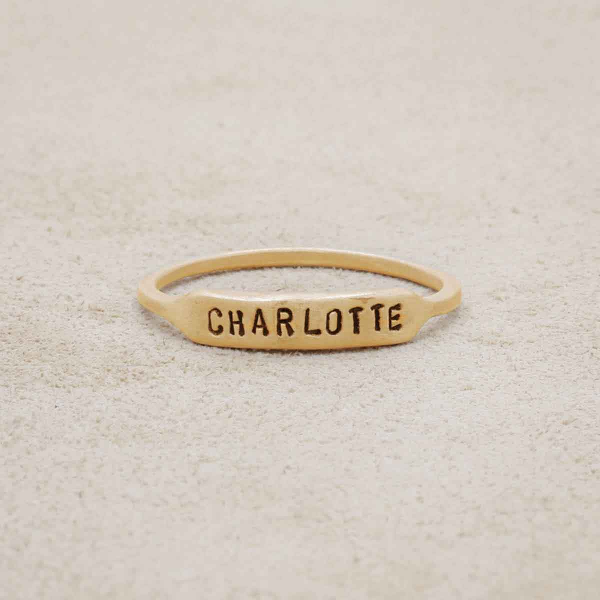 14k yellow gold personalized Nameplate Stacking Ring on a beige background