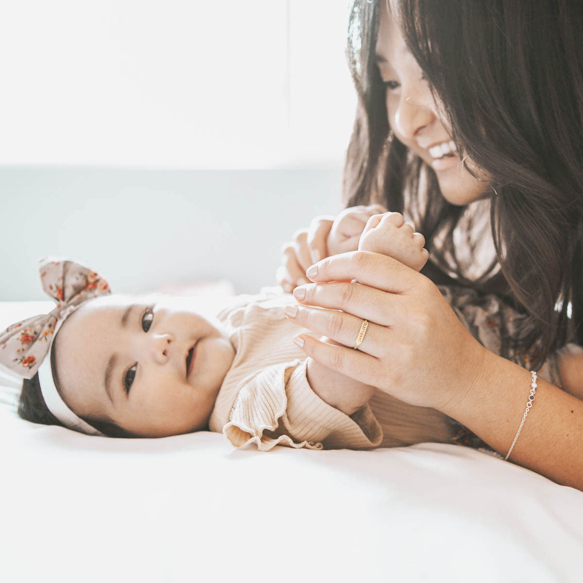  holding her baby's hand