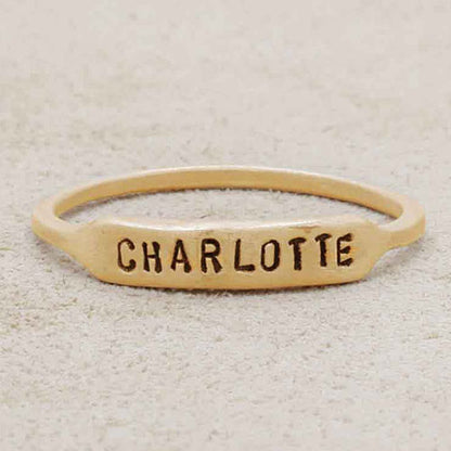 14k yellow gold personalized Nameplate Stacking Ring on a beige background