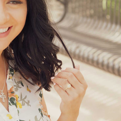 Girl wearing Nesting freshwater large pearl ring hand cast in 10k yellow gold holding inside a large 6mm freshwater pearl 