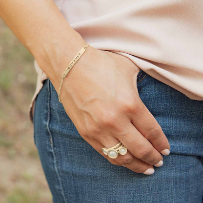 Girl wearing Nesting freshwater large pearl ring hand cast in 14k yellow gold holding inside a large 6mm freshwater pearl 