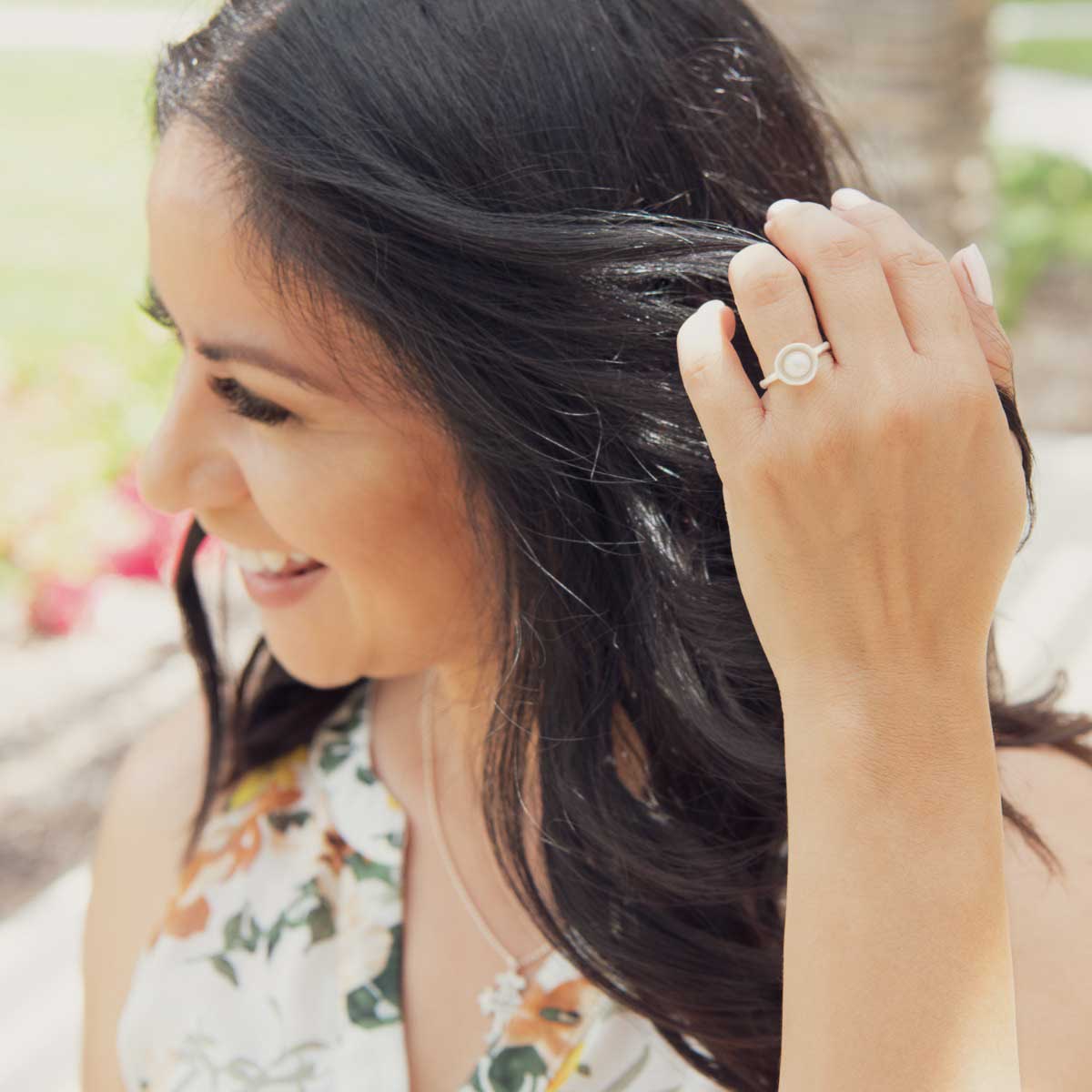 Girl wearing Nesting freshwater large pearl ring hand cast in sterling silver holding inside a large 6mm freshwater pearl 