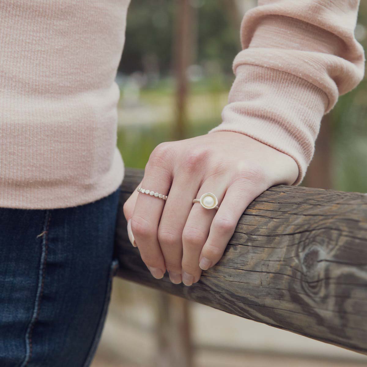 Girl wearing Nesting freshwater large pearl ring hand cast in sterling silver holding inside a large 6mm freshwater pearl 