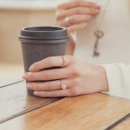 Girl wearing Nesting freshwater large pearl ring hand cast in sterling silver holding inside a large 6mm freshwater pearl 