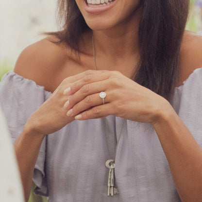 Girl wearing Nesting freshwater large pearl ring hand cast in sterling silver holding inside a large 6mm freshwater pearl 