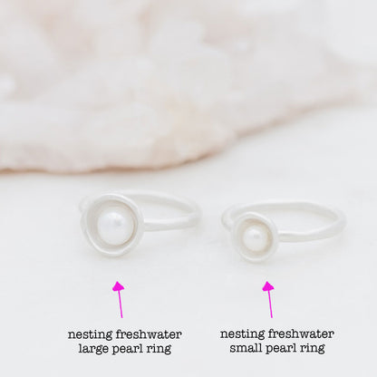 Nesting freshwater large pearl ring hand cast in sterling silver holding inside a large 6mm freshwater pearl 