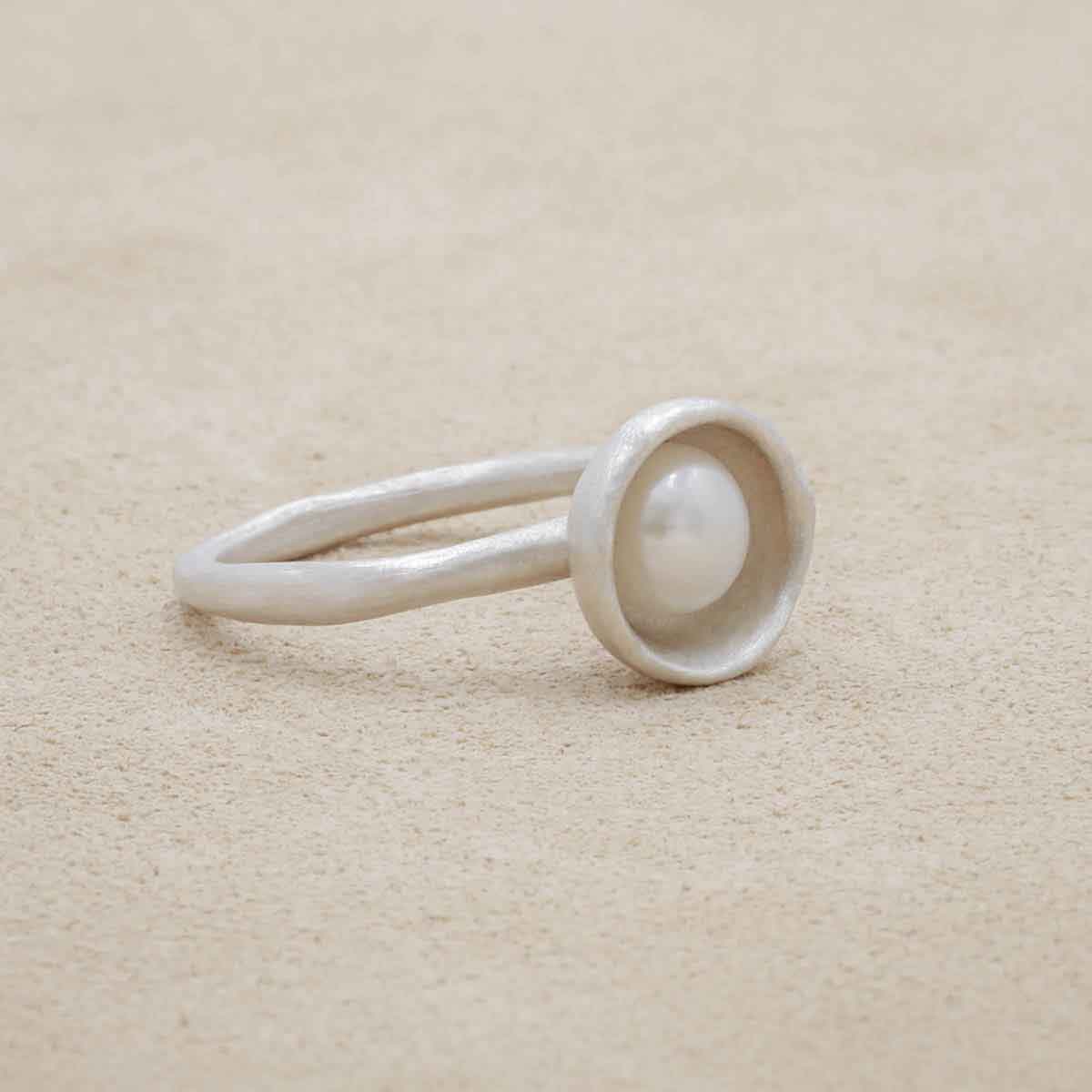 Nesting freshwater large pearl ring hand cast in sterling silver holding inside a large 6mm freshwater pearl