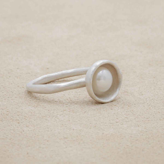 Nesting freshwater large pearl ring hand cast in sterling silver holding inside a large 6mm freshwater pearl